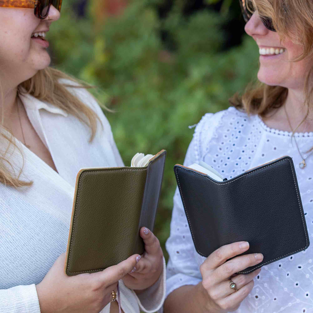 Two friends with pocket notebooks